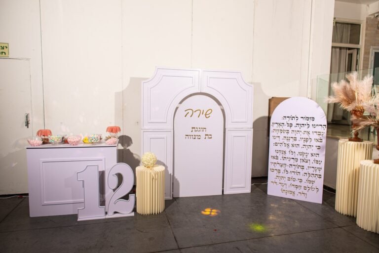 קיר כניסה לבן עם המספר 12 ופמפס